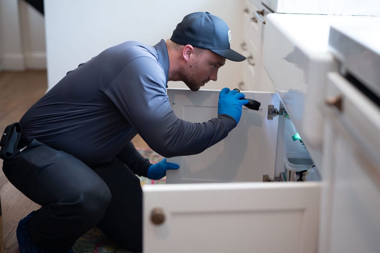 Hawx pest control technician inspecting